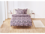 A mauve floral duvet cover set on a bed in a light and airy bedroom.