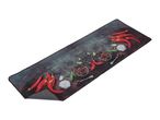 A kitchen mat featuring red chili peppers, garlic, and spices on a dark background.