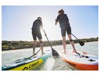 Two people paddleboarding on Crivit inflatable SUPs.