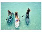 Three people paddleboarding on inflatable boards in turquoise water.
