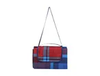 Folded red and blue plaid picnic blanket with a shoulder strap.