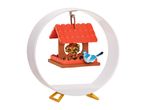 A miniature bird feeder ornament with a bluebird, displayed on a circular stand.