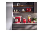 Red retro-style kitchen appliances including a stand mixer, juicer, and blender on a countertop.