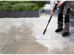 A person cleans paving stones with a Parkside pressure washer.
