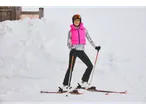 Woman in ski gear, including a ski undershirt, in the snow.