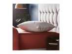 A white pillow with the word 'COPPER' on it rests on a red bed with a tufted headboard.