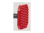 Red plastic foot pedal with a textured, non-slip surface and a black attachment.