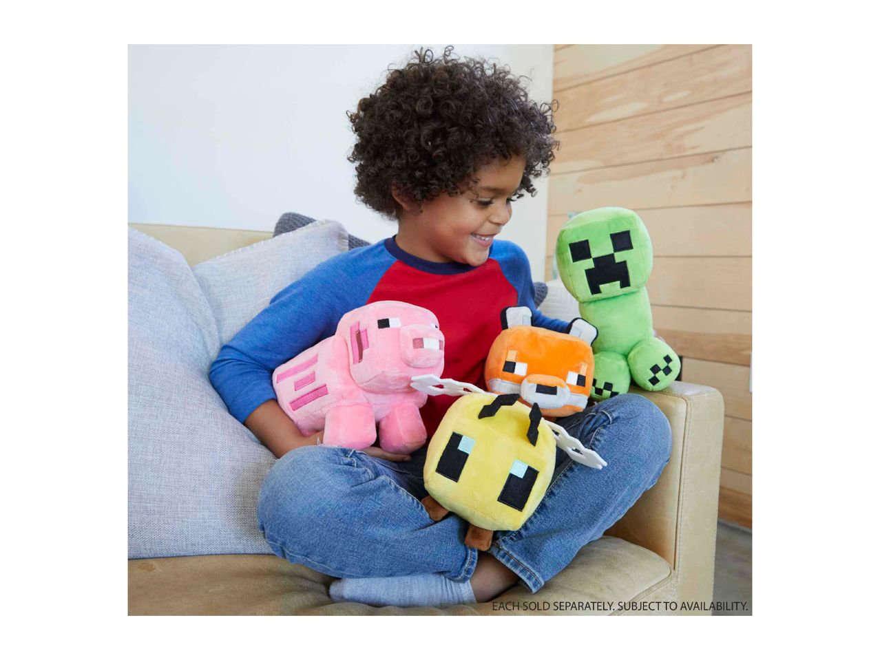 A smiling child holding a pink pig, orange fox, yellow bee, and green creeper plush toys.