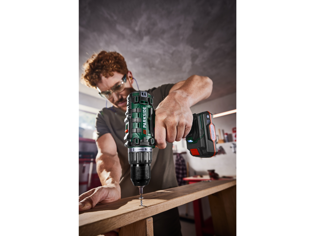 Man using a Parkside cordless drill for woodworking.