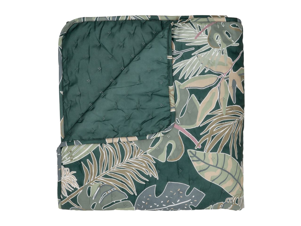 Quilted blanket with a tropical leaf pattern in shades of green, beige, and white.
