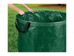 Hands opening a green garden waste bag with handles, set against a grassy background.