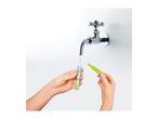 Hands filling a colorful tube with water from a chrome faucet.