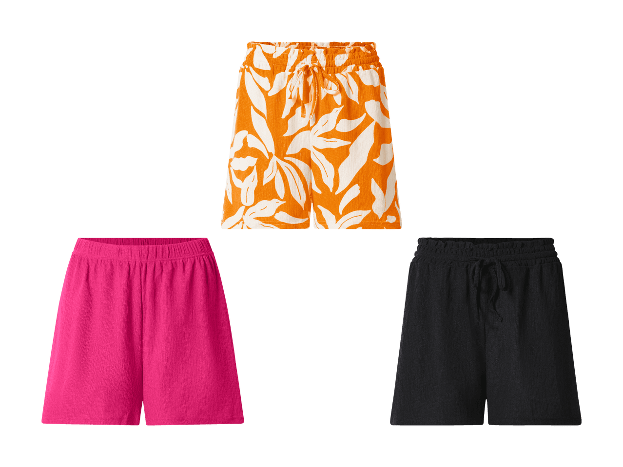 Trois shorts d'été : un orange à motifs blancs, un rose uni et un noir uni.
