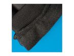 Close-up of black ribbed fabric and fuzzy material on a blue background.