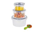 Stack of three round food storage containers, two filled with food, with a tomato and basil.