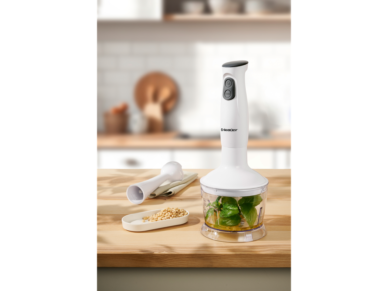 SilverCrest hand blender and food processor with ingredients on a wooden counter.