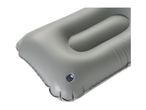 Close-up of a grey inflatable camping pillow with a blue valve.