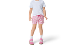 Child wearing a white t-shirt and pink jersey shorts with a cartoon pig pattern.