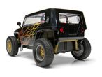 Black toy off-road vehicle with flame decals and gold wheels, viewed from the rear.