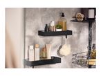 Black shower caddies with various bath products, including shampoo, conditioner, and a loofah.