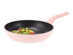 A pink frying pan with a black speckled interior, containing stir-fried vegetables.