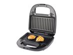 Open electric grill with two grilled chicken breasts