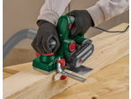 Electric planer in use, with a wooden beam being planed.