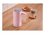Pink milk frother on a wooden counter next to a latte and croissants.