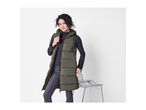 Woman in a long olive green puffer vest, dark gray long-sleeve top, and dark jeans.