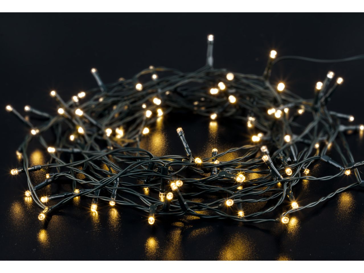 Warm white LED string lights on a dark surface