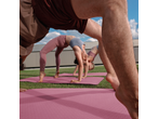 People doing yoga on CRIVIT Yoga Mats outdoors, in a wheel pose.