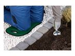A person kneeling on a green garden kneeler pad while planting in the soil.