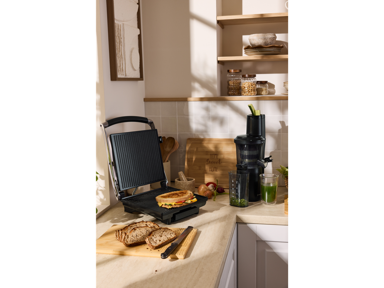 SILVERCREST® Premium Slow Juicer and grill press on a kitchen counter with food.