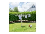 Rotary clothesline with laundry drying in a sunny garden with a house in the background.