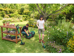 Man with Parkside® lawnmower, woman with Parkside® 20V Cordless Grass Trimmer in garden.