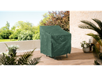 A green protective cover on a patio chair on a wooden deck with plants and a stone wall.