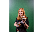 A woman holding two Big Tasty Pot Beef Stew containers against a green background.