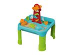 Colorful sand and water play table with a water tower, sand molds, and beach toys.