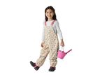 Smiling girl in floral print waterproof overalls holding a pink bucket and spade.