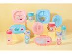 A collection of Peppa Pig themed children's dinnerware, bottles, and pacifiers.