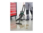 Wet and dry vacuum cleaner cleaning a liquid spill on a workshop floor next to a tool chest.