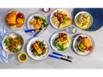 A variety of meals including burgers, pasta, salmon, chicken, and shrimp dishes.