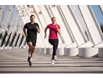 Man and woman running, woman wearing a CRIVIT Ladies' Short Sleeve Sports Top.