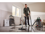 Man using a PARKSIDE® 1400W Wet & Dry Vacuum Cleaner to clean a wet floor.