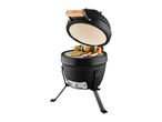 Black ceramic kamado grill with an open lid, grilling meat and vegetable skewers.