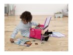 Child playing with a wooden activity desk, puzzles, and coloring cards on a wooden floor.