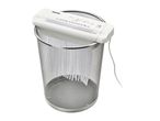 A small, white personal shredder sits atop a clear cylindrical container.