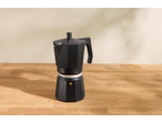 Espressor negru SILVERCREST pe o masă de lemn cu cafea măcinată.
