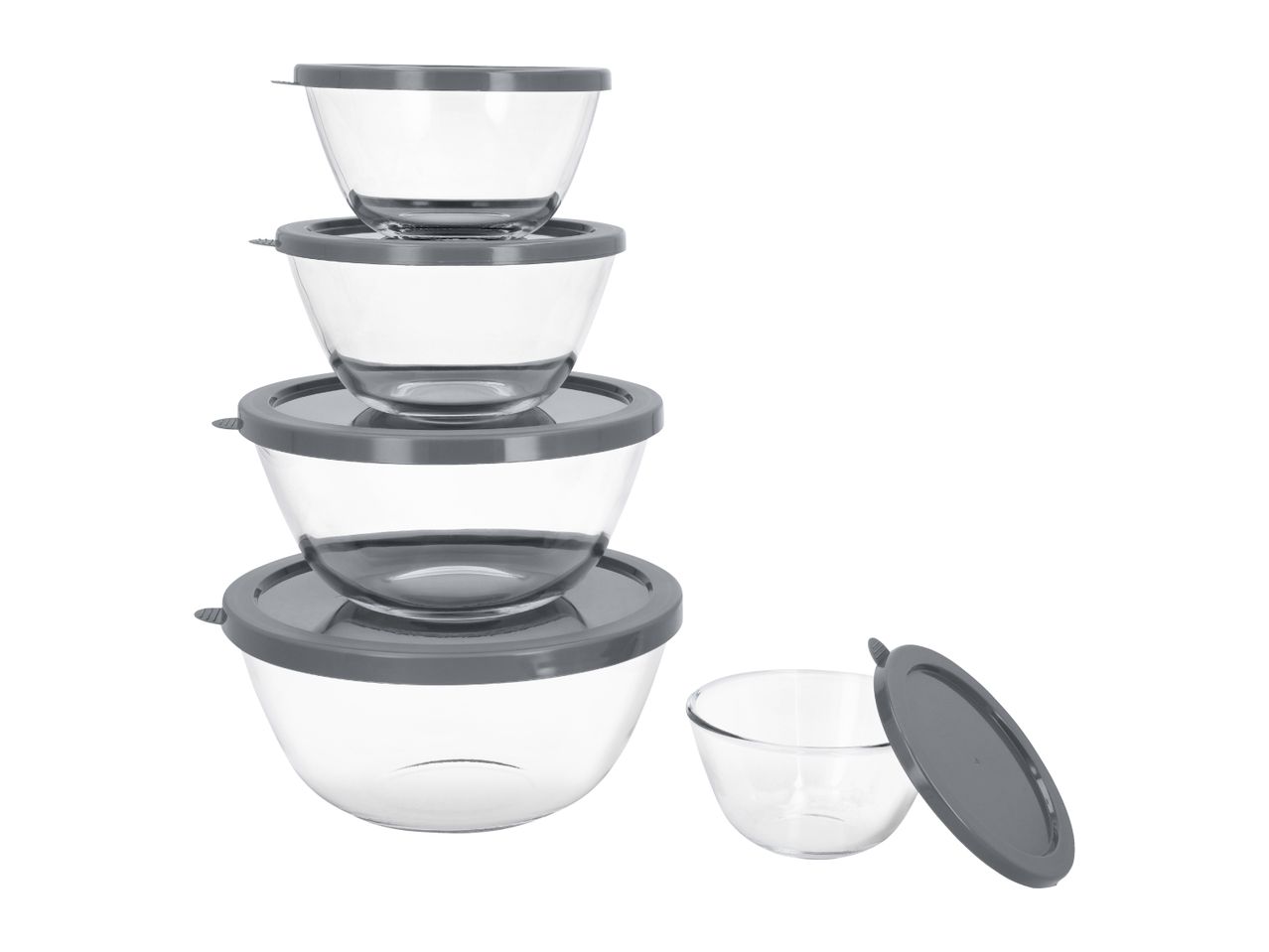A stack of four clear glass mixing bowls with grey lids, and one smaller bowl with a lid beside them.