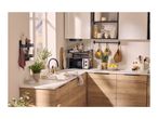 A modern kitchen with wooden cabinets, white countertops, a microwave, and various kitchen accessories.